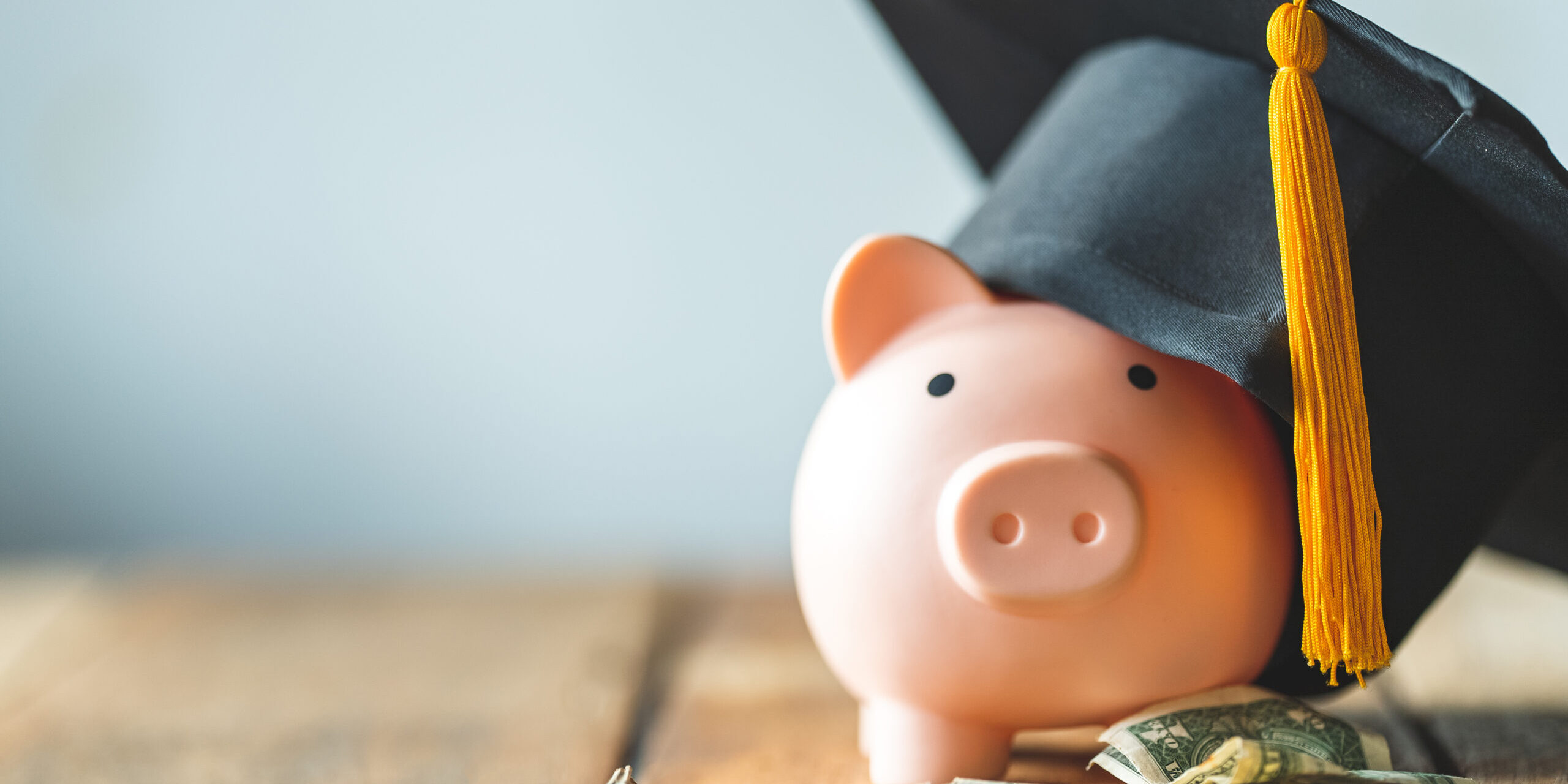 piggy bank With Graduation Cap on old wood,Money saving concept.
